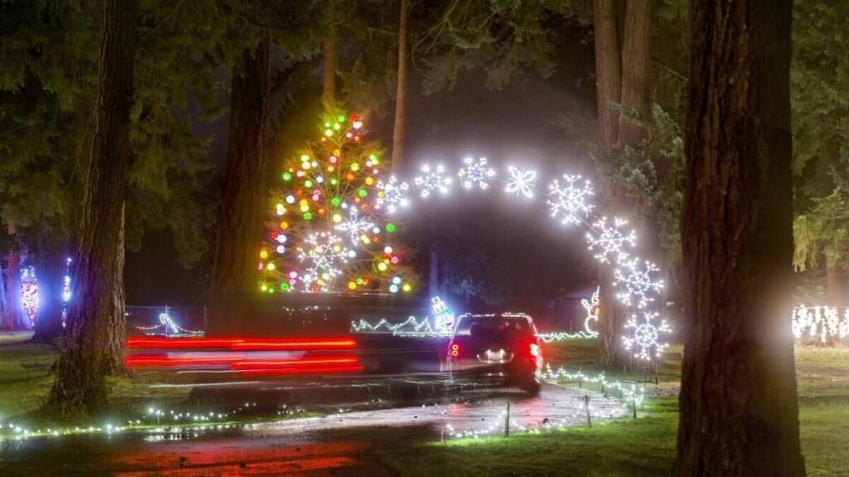 Cars slowly move through Pierce County’s Fantasy Lights in Spanaway Lake Park.