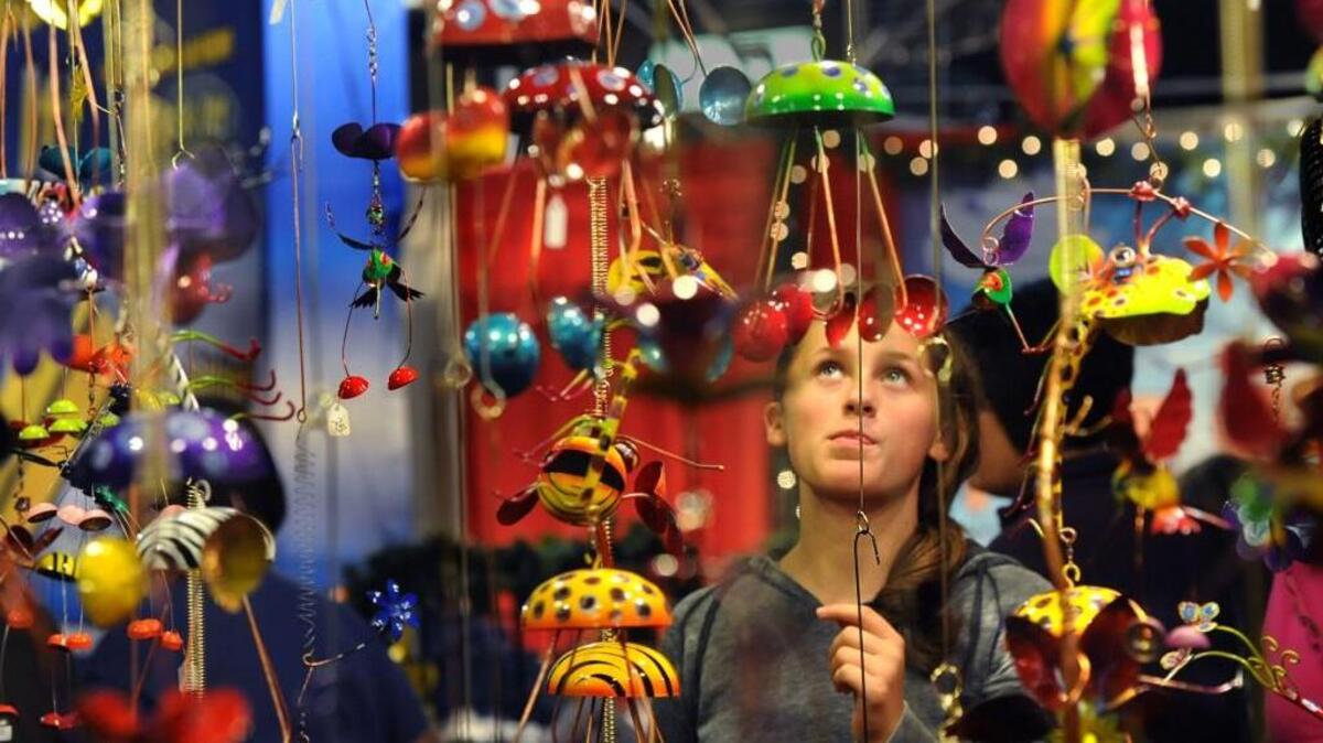 Abby Scott looks at garden ornaments at the Juana Pena Designs display at the Annual Tacoma Holiday Food & Gift Festival at the Tacoma Dome in 2011.