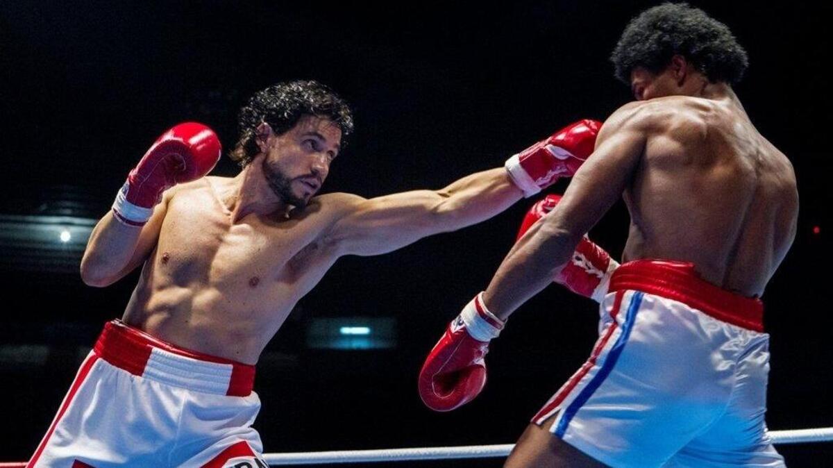 Edgar Ramirez, left, as Roberto Duran, throws a punch at Sugar Ray Leonard (played by Usher Raymond), in “Hands of Stone.”