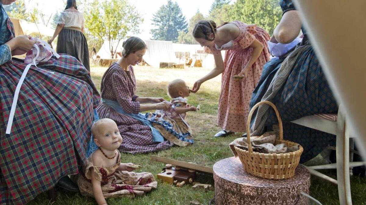 
Women stitch clothing and care for the young during Brigade Encampment at Fort Nisqually in Point Defiance Park in 2012. Sunday is the final day of this year’s event
