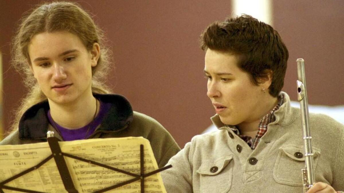 Tacoma Symphony principal flute Mary Jensen coaching a young musician.