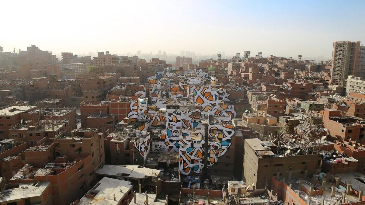 El Seed’s “Perception” is an art project on the sides of 50 buildings in Cairo. It is part of a photographic exhibit at Matter Gallery in Tacoma.