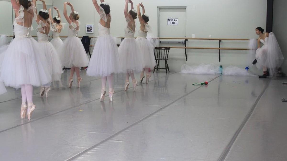 Katharine Cowan, right, as the spirit of Giselle, waits to join the Wilis (ghost girls) danced by the corps de ballet of Studio West, Olympia, in rehearsal.