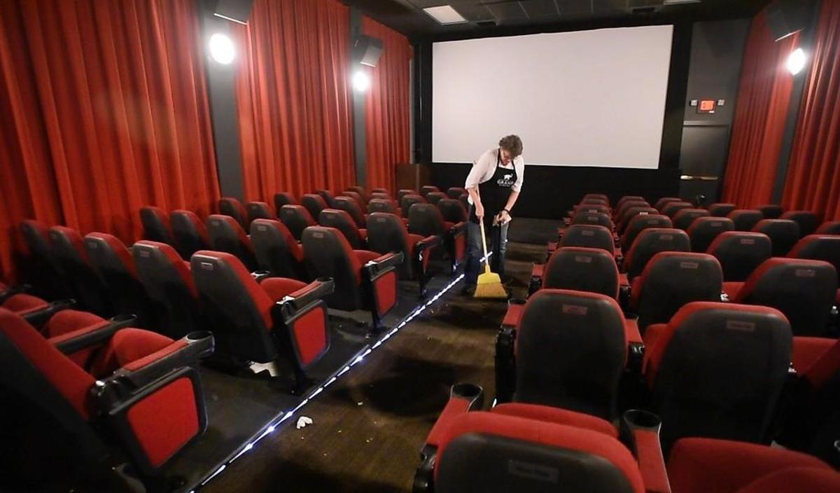 A volunteer at the Grand Cinema sweeps up after a film showing in 2017.