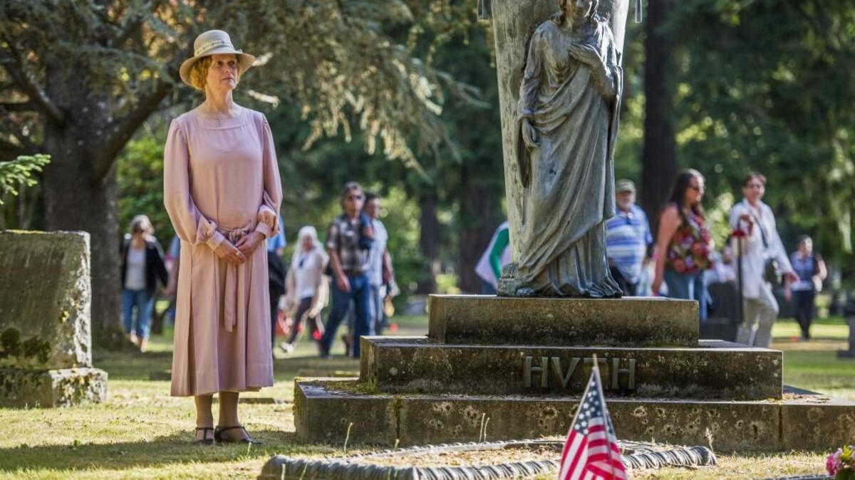 Agnes Muehler Huth (as portrayed by Karen Haas) waits by her grave monument for the audience to arrive, part of the Tacoma Cemetery Living History Tour, July 18, 2014.