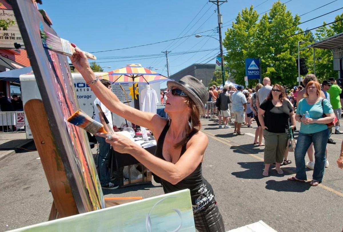 Teresa Oltman of Ashford at Art on the Ave in 2013. The annual festival on Tacoma’s Sixth Avenue won’t take over the street in 2022, but it will feature artists outside businesses and in parking lots.