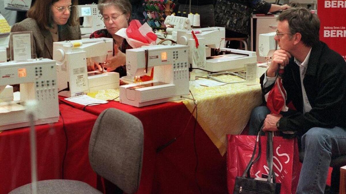 You can learn about sewing this weekend at the Sewing & Stitchery Expo in Puyallup. Here, from left, Christine Freed tests out a sewing machine with saleswoman Bobby Smead and Christine’s husband, Jim Freed, at the Sewing & Stitchery Expo.