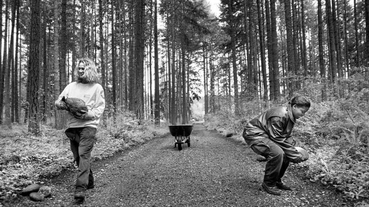 Sarah Luckey, 20, of Santa Rosa, Ca. (left) and Judy Thomas, 20 of San Diego, Ca. place stones along the driveway into Morse Wildlife Reserve in Graham in 1996.