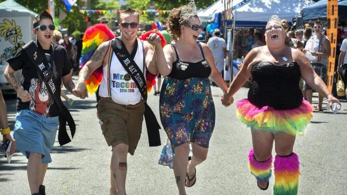 Lili, Ms. Gay Tacoma, left to right, Hayden Eyesli, Mr. Gay Tacoma, Alicia Ross, Imperial Princess, and Angela Hadway, debutante,  enjoying the Tacoma Pride Festival on Saturday, July 12, 2014.