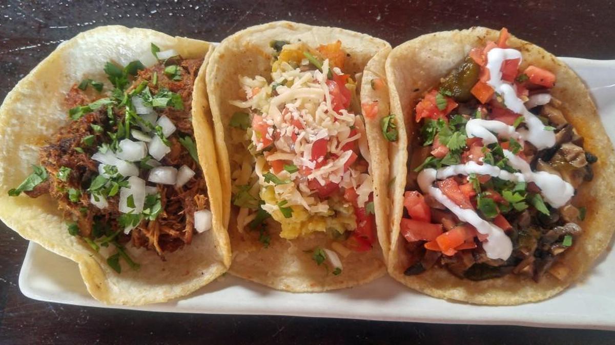 A trio of tacos, including, from left to right, vegan, potato-poblano and a vegan mushroom taco.