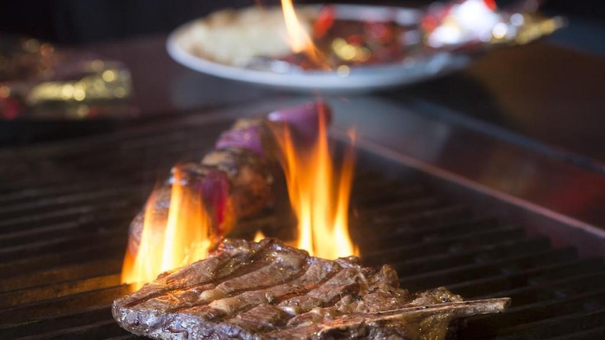 A rib steak on the grill at the Zodiac Supper Club in Tacoma.