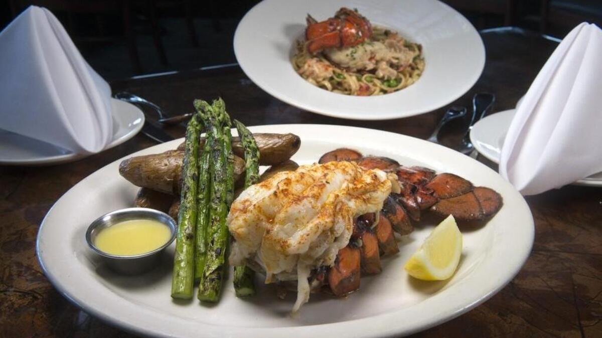 Pictured is a 12-ounce Maine lobster tail with truffle-salted fingerling potatoes and grilled asparagus at the Lobster Shop restaurant on the Tacoma waterfront. In the background is lobster carbonara with bacon, shallots and peas in a sherry cream sauce.