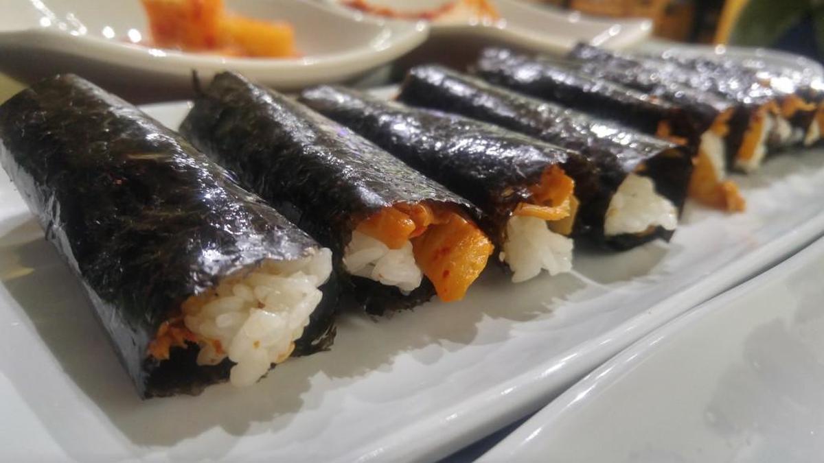 Kimchi kimbap is pictured here. Get the mini kimbap rolls with one of six kinds of fillings.