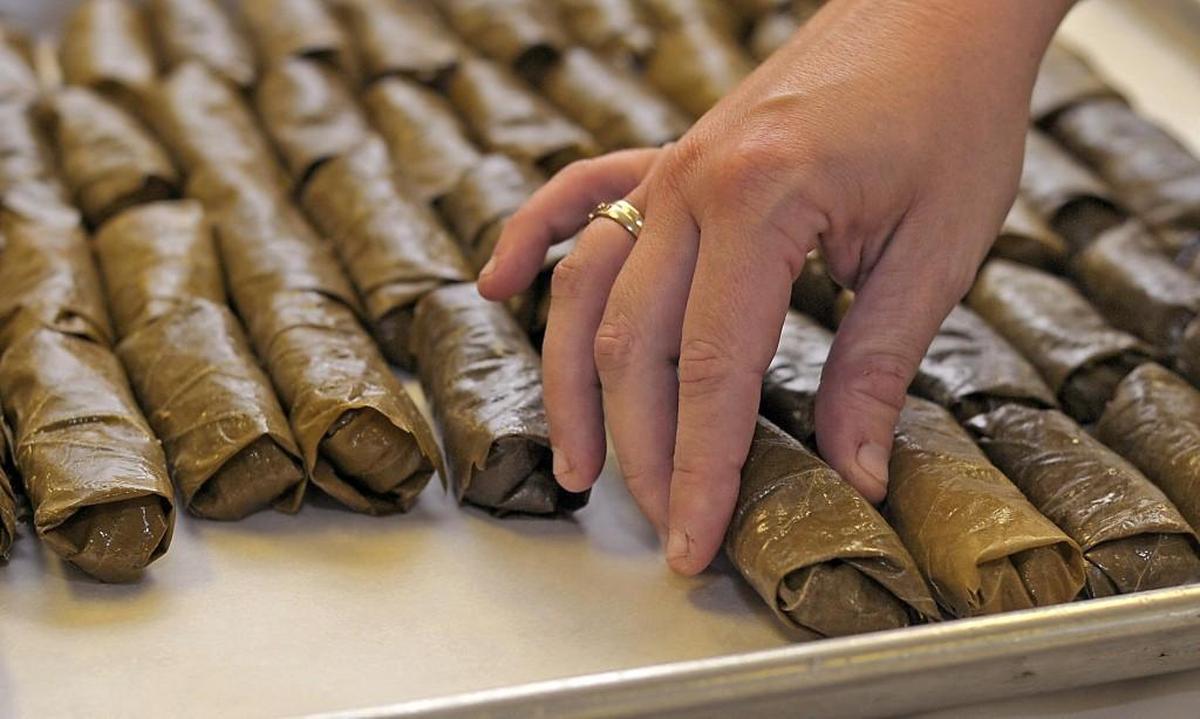 A group of women work together at St. Nicholas Greek Orthodox Church making thousands of dolmades for the annual Greek Festival. August 17, 2011.