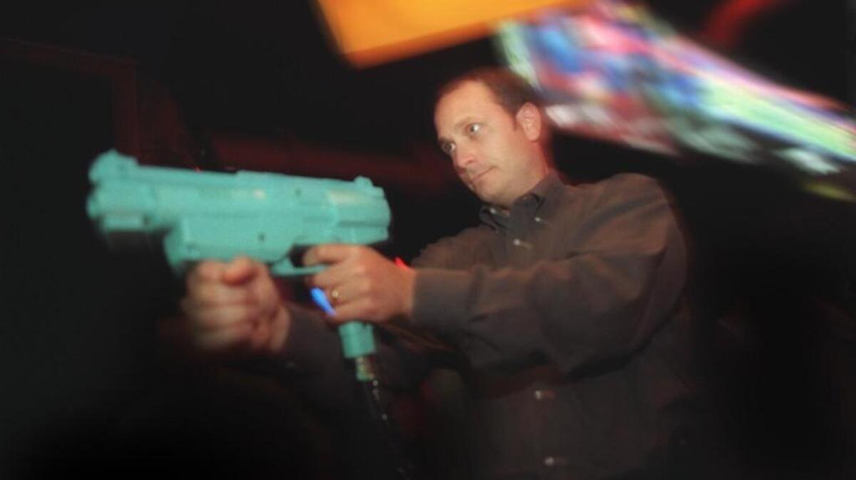 Mitch deCaire plays the CrisisZone game at Dave & Buster’s at the Great Mall in Milpitas, California.