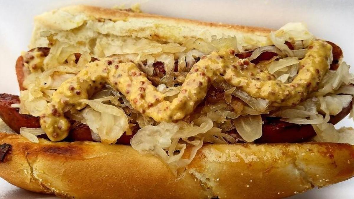 A German sausage with grilled sauerkraut from Mikey’s Wiener Trap, a mobile hot dog cart that operates across the street from the County-City Building on Tacoma Avenue.