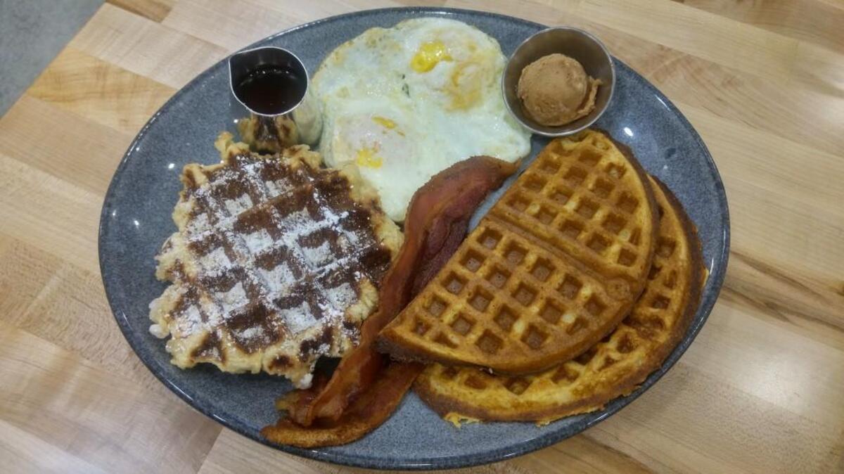 Waffle breakfast combos, such as this one, include eggs and breakfast meats. Find a long list of savory and sweet waffles at newly opened Waffle Stop in Tacoma’s Proctor neighborhood.