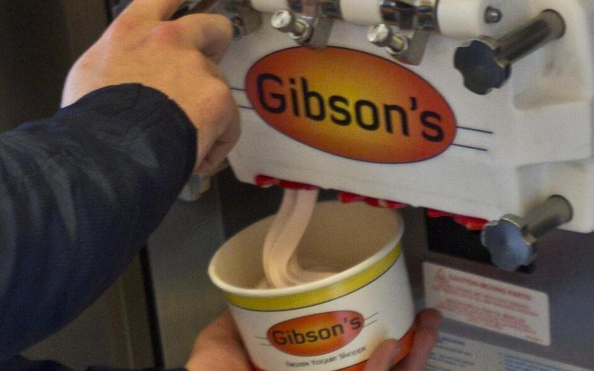 Tacoma resident Andrew Pudists fills a container with frozen yogurt during his first visit to Gibson’s Frozen Yogurt Shoppe in Tacoma in 2012. The frozen yogurt shops closed last week.