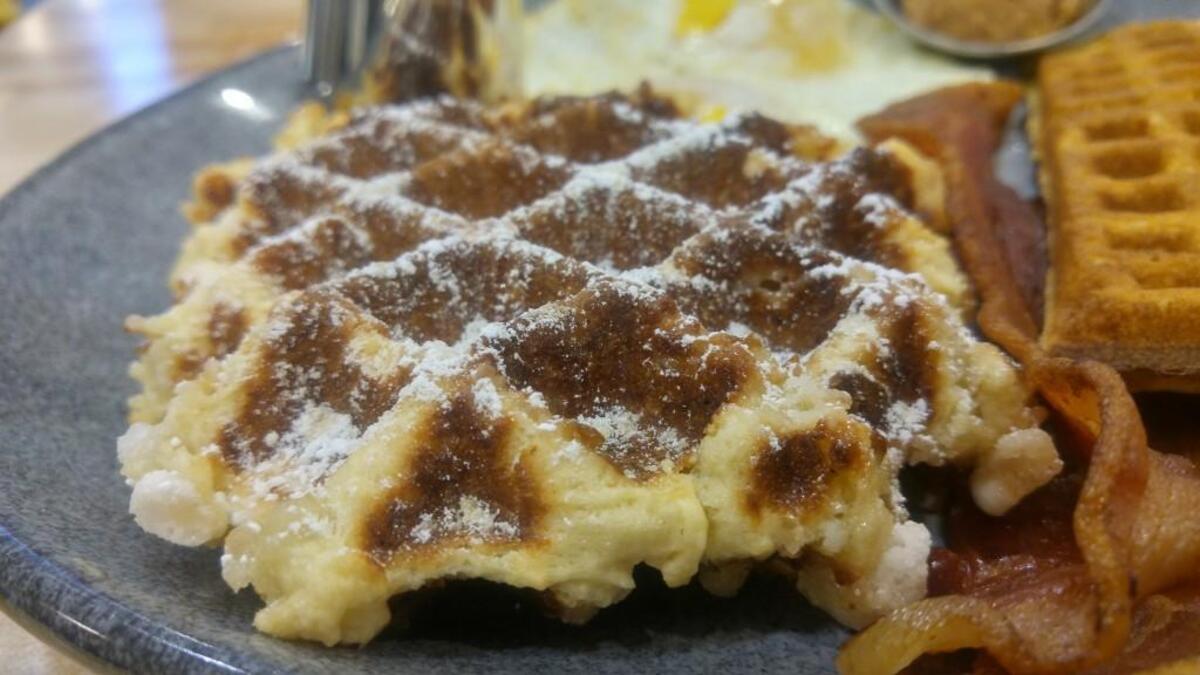 A pearl sugar waffle is embedded with sugar crystals that caramelize as the waffle cooks on the griddle.