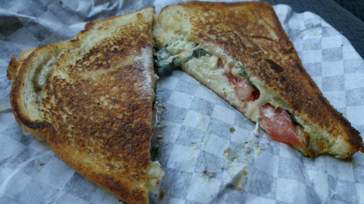 Sandwiches at Gnosh come loaded with cheese. This one is a Caprese with mozzarella, diced tomatoes and whole fresh basil leaves.