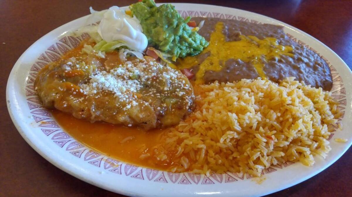 A battered chile relleno made with a poblano pepper and served with rice and beans from Don Chuy restaurant.
