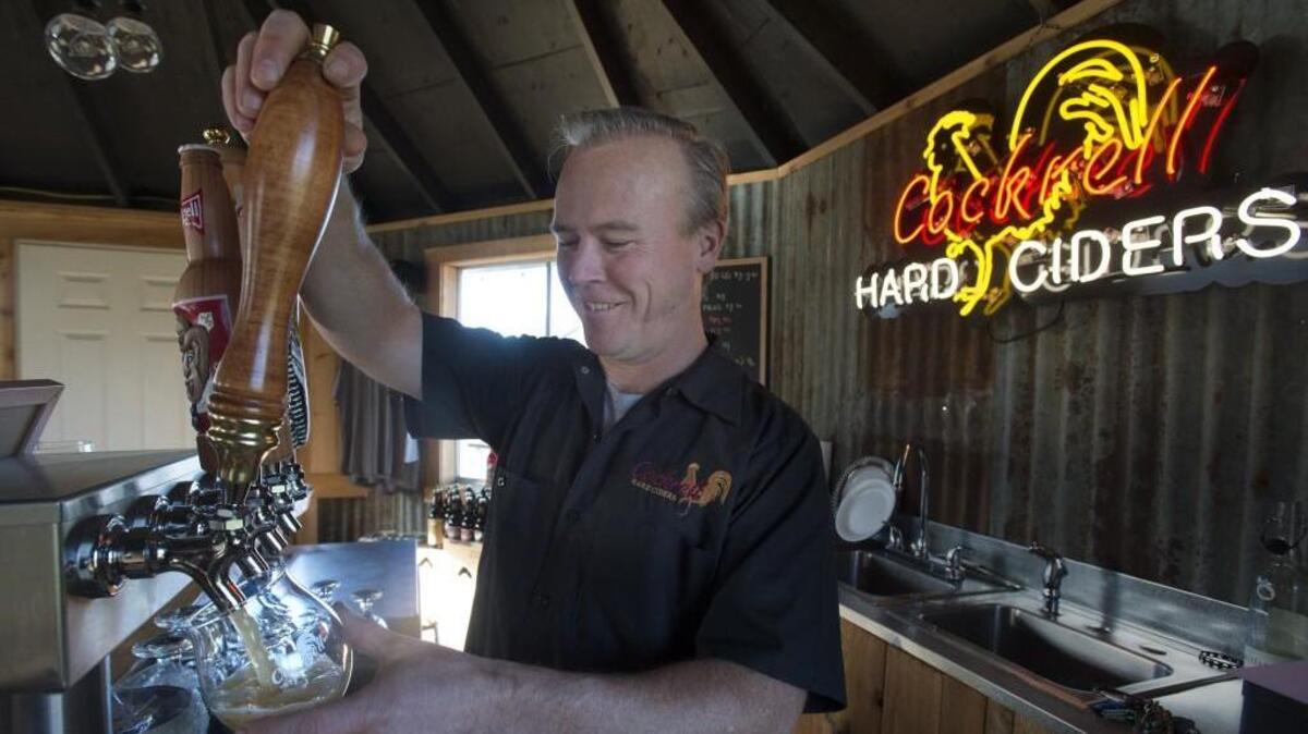 Owner Rich Cockrell pours cider at the Cockrell Hard Cider tasting room in Puyallup. Cockrell will be among the cider makers whose ciders will be poured at the Cider Swig in Gig Harbor.