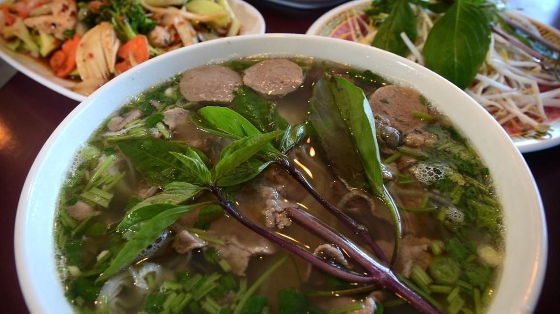Pho Bo Dac Biet, beef meatball with rice noodle at Vien Dong. Com Ga Xao Sa Te, saute chicken in spicy sauce with rice is at upper left.