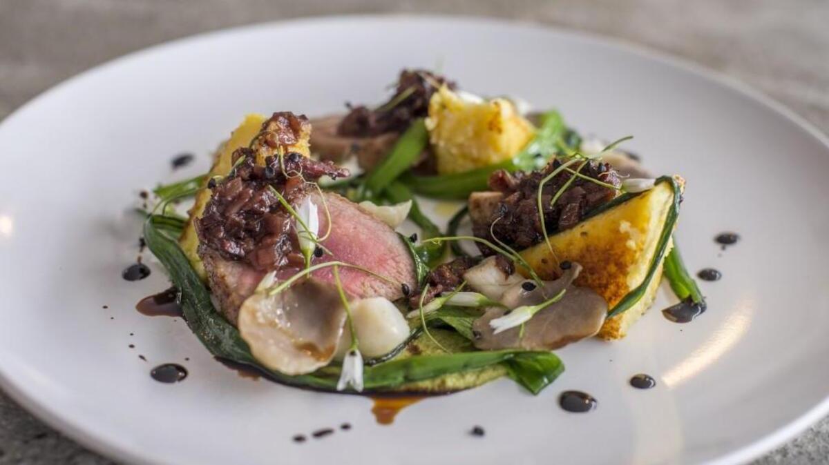 Tails ’n’ Trotters roasted pork tenderloin with seared polenta, fiddlehead puree, oyster mushrooms and wild leeks, made by Blake Lord-Wittig, owner and chef of De La Terre in Steilacoom.