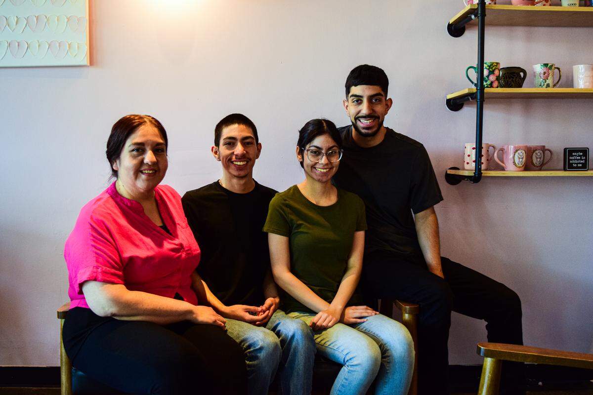 With the food truck and cafe, it’s a family affair. From right: Eduardo, Brianna and Emilio Amaral sit with their mother Yonilda Morales on Wednesday, July 23.