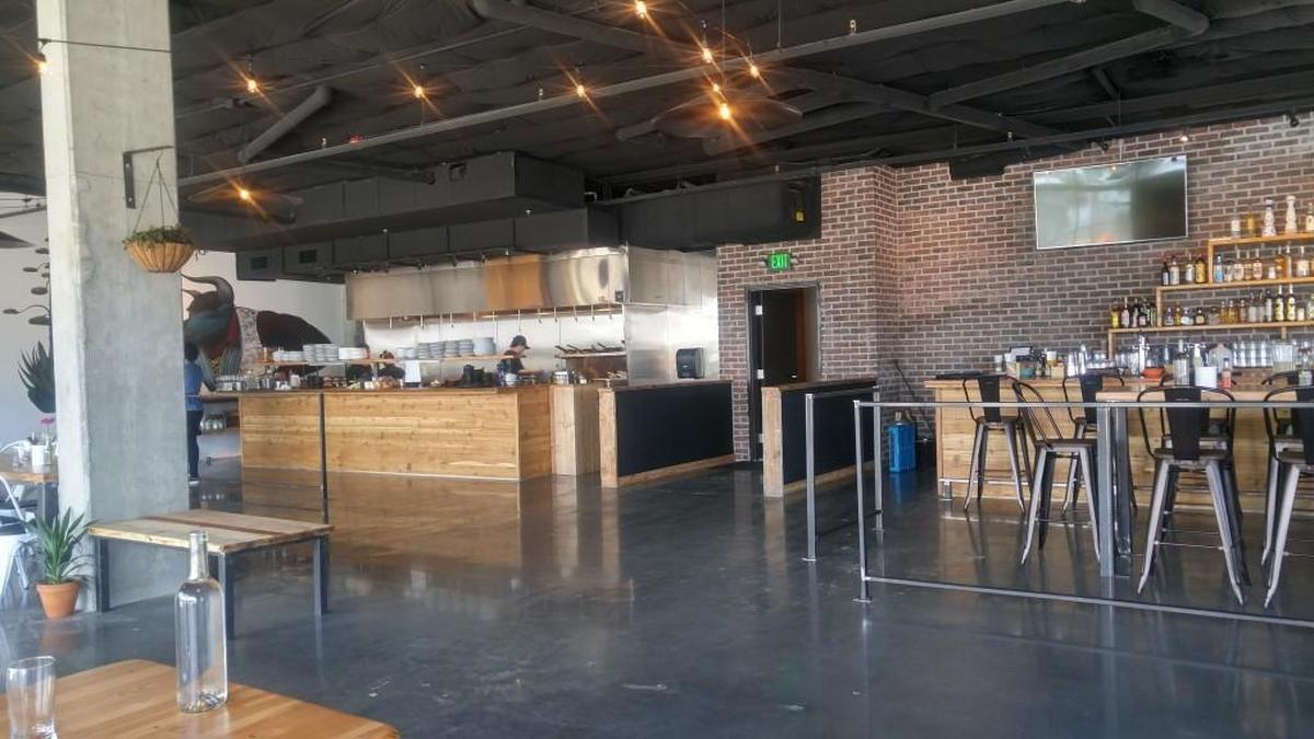 An open kitchen flanks the bar at Casco Antiguo.