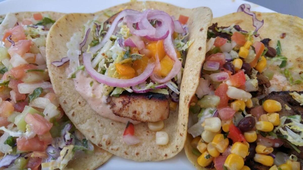 A trio of tacos from WildFin American Grill on the Tacoma waterfront. On the left is a cajun fish taco, in the center is a jerk-spice flavored chicken taco and on the right is the wagyu beef taco.