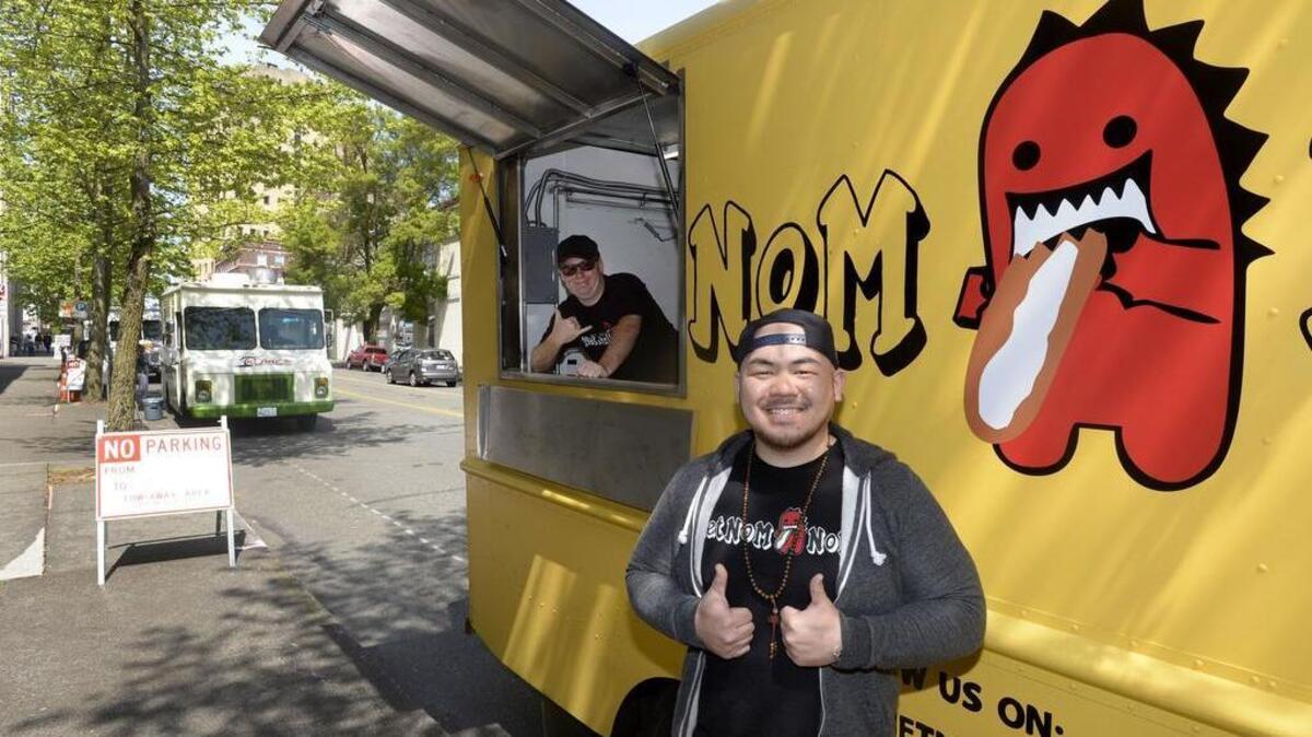 
Vietnom Nom co-owners Andy Huynh, right, and Chris Wetzler were thumbs up after selling out during the first-ever food truck rally on Market Street in Tacoma on May 1. Vietnom Nom specializes in bahn mi sandwiches and rice bowls.

