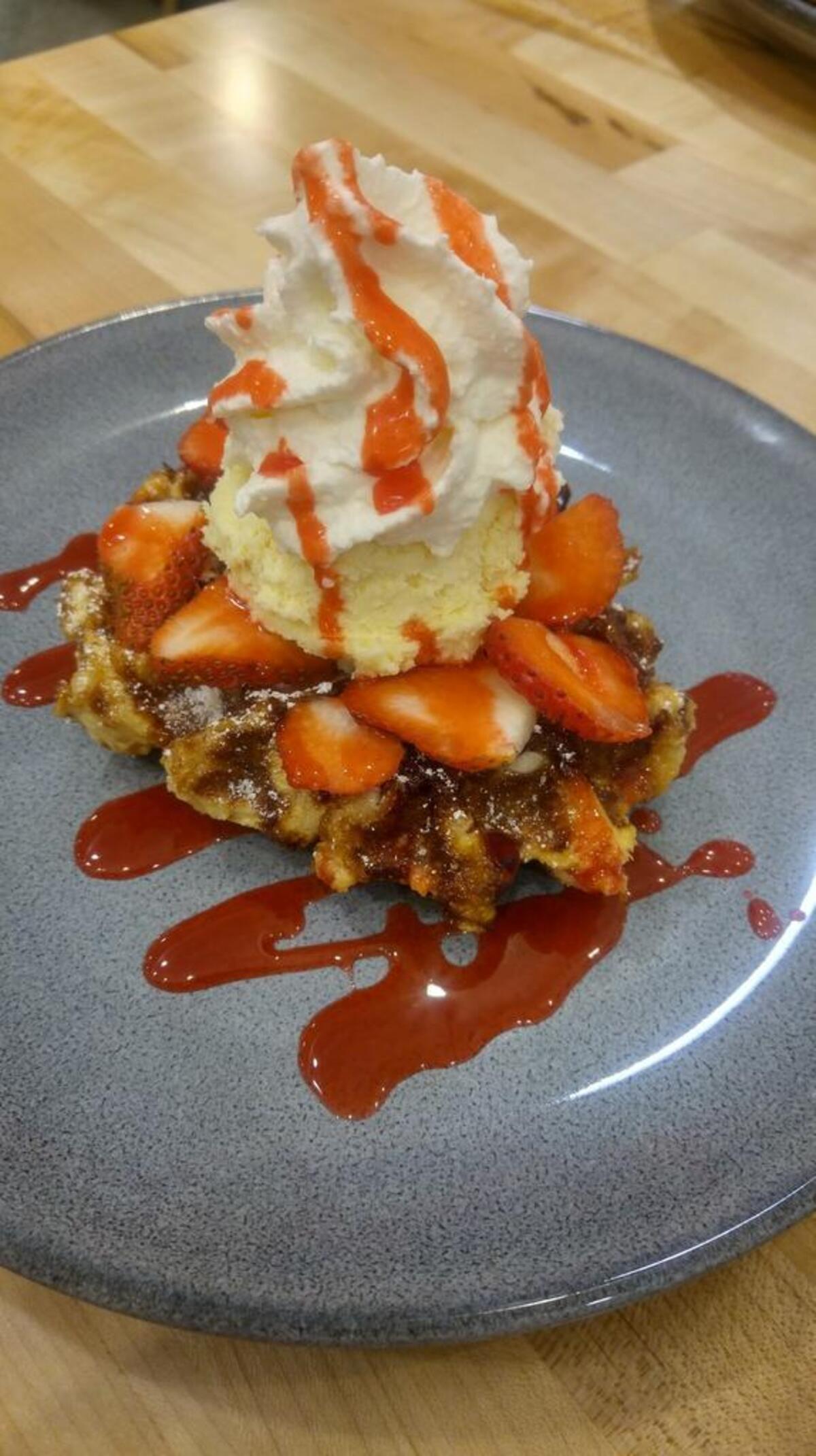 A delicious strawberry cheesecake waffle is on the sweet menu at Waffle Stop.