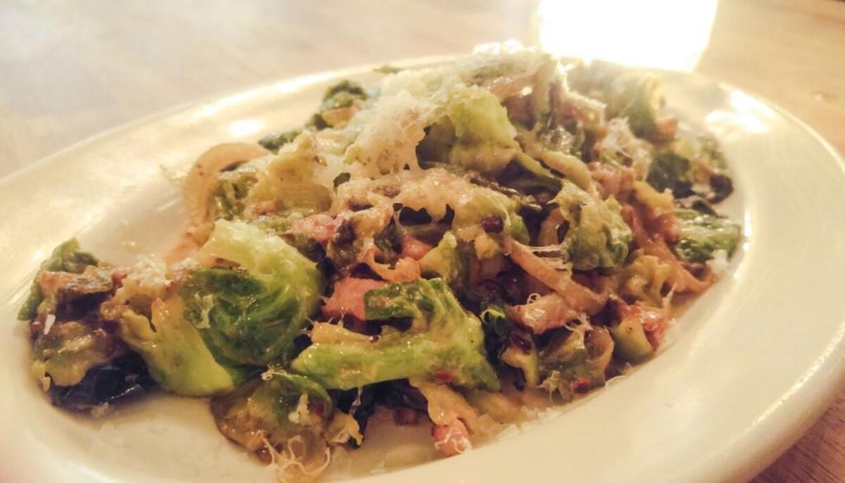 The Brussels sprouts at Gertie and the Giant Octopus in Gig Harbor are sauteed with pancetta and finished with cream and sherry. Manchego cheese is grated onto the dish just before its served.
