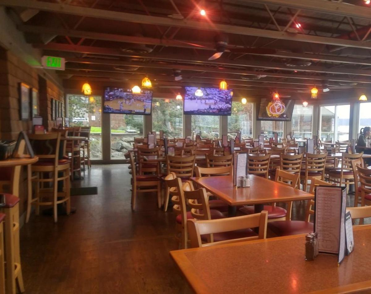 The dining room at Katie Downs has floor-to-ceiling windows with a stunning view of the Ruston waterfront.