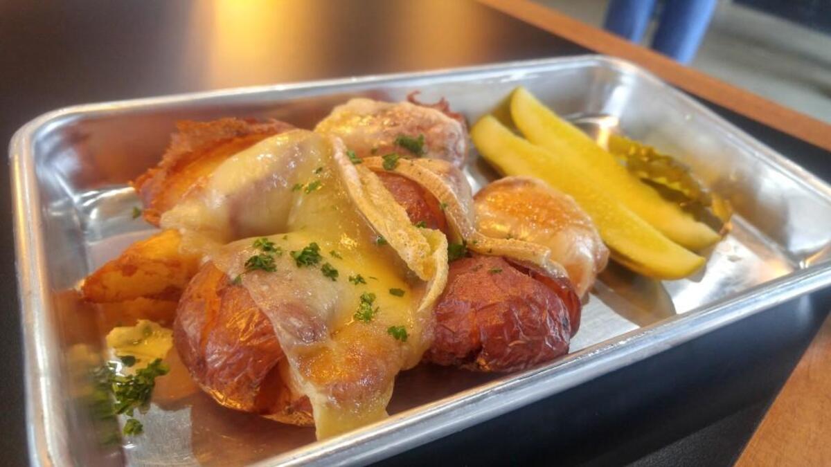 Creamy raclette drapes across potatoes at Burche.
