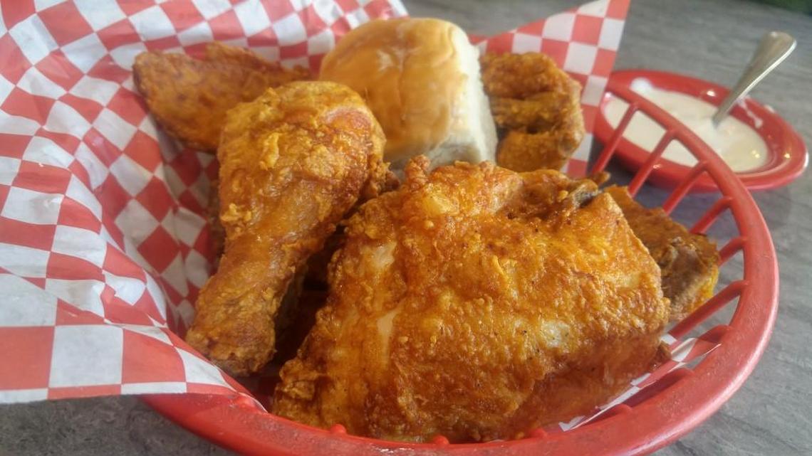 A four-piece fried chicken basket with jo-jo potato wedges and a roll.