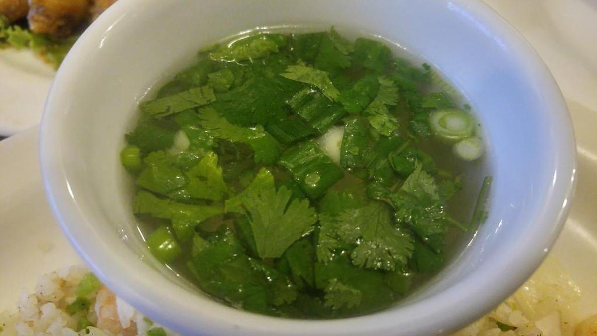 A bowl of soup with a floating raft of cilantro at La Cà Bar.