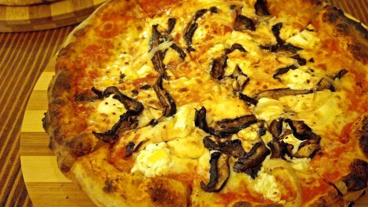 A mushroom pizza, called the Home 2, at Millville Pizza Co., where all the pies are named after historic boats of Gig Harbor.