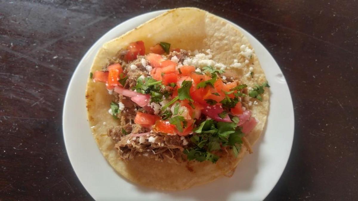 Duck carnitas are topped with pickled red onions at Seattle’s El Borracho in Ballard.