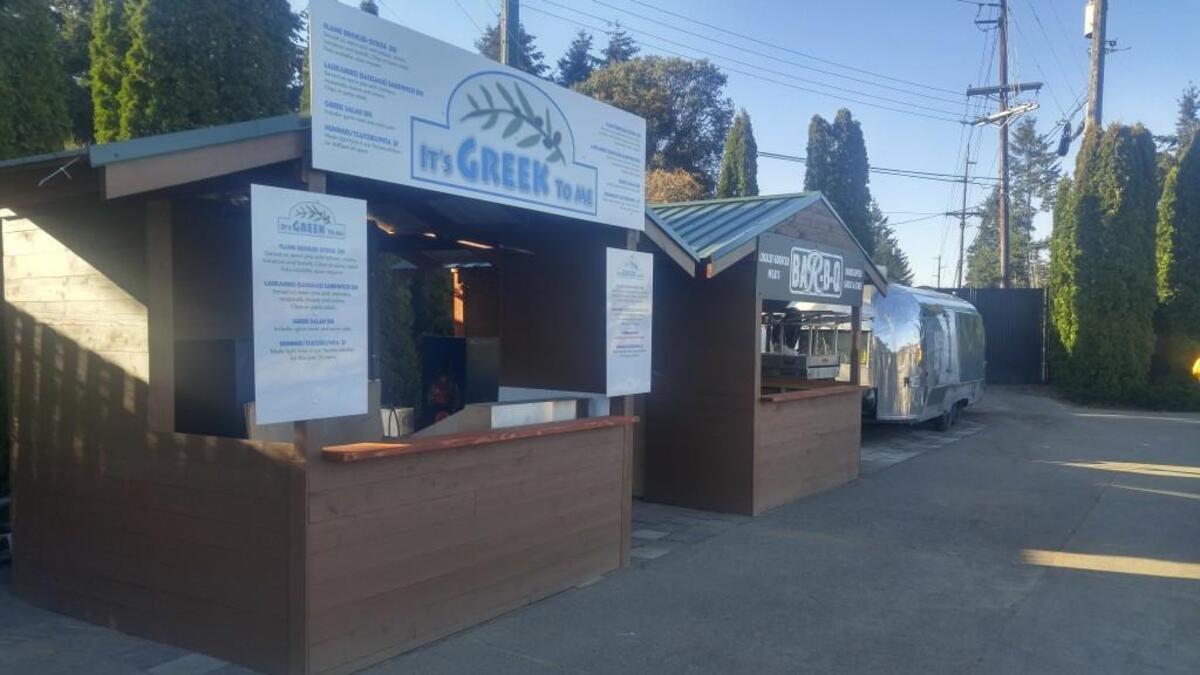Find the It’s Greek To Me stand on the upper terrace walkway at Cheney Stadium.