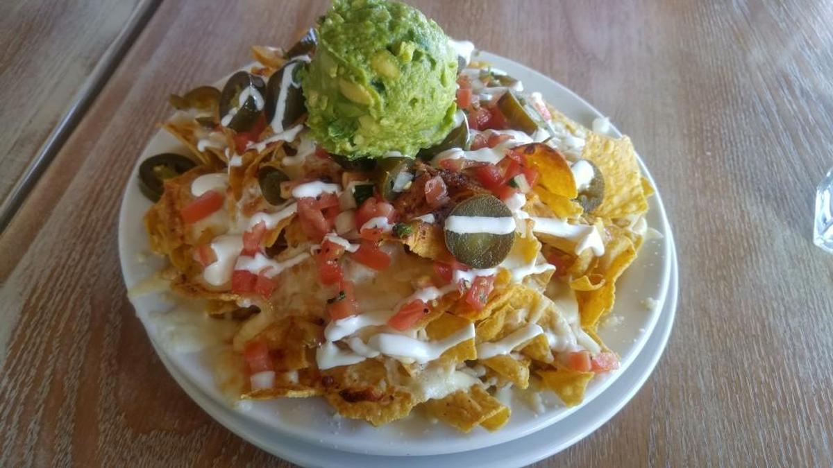 Nachos at El Borracho come topped with a scoop of guacamole.