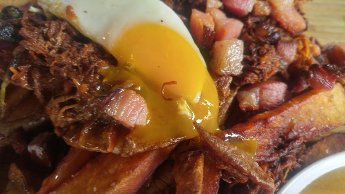 If you do it right, you’ll pierce the yolk of the fried egg so that it soaks down to the bottom layer.