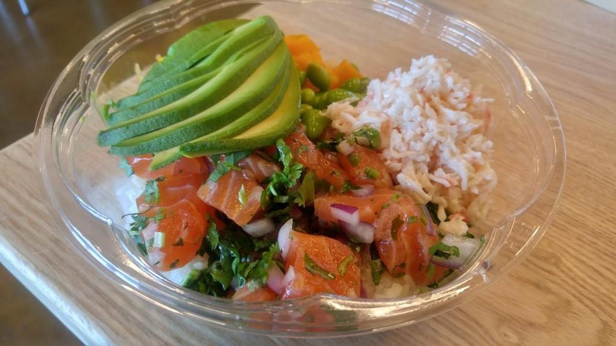 Salmon poke bowl is served with a choice of a salad base, or white or brown rice.