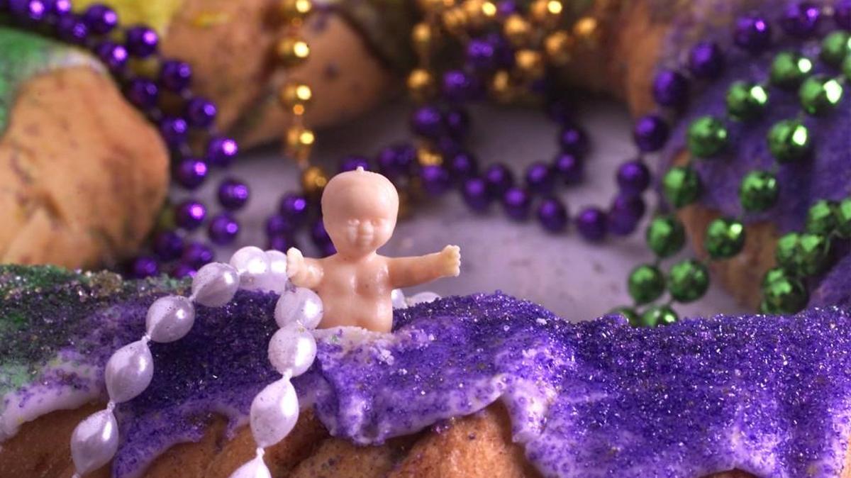 Little plastic babies are traditionally baked inside colorful King Cakes.
