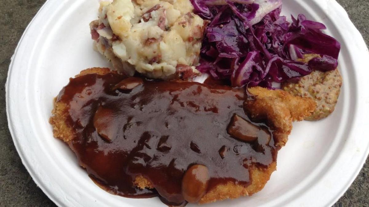 A pork schnitzel plate from Gutes Essen Haus at Oktoberfest Northwest. Served with warm German potato salad and sweet-and-sour red cabbage.