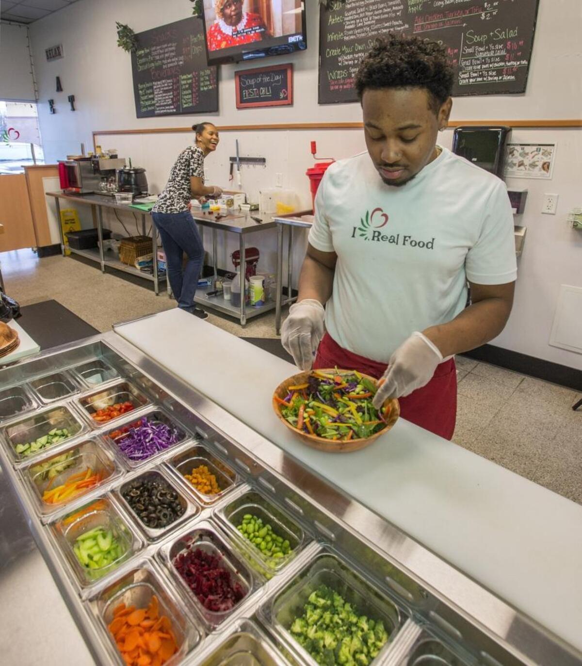 Dion Cooper makes a Temple salad while business partner Nyesha Jones does prep at Garden's Gourmet Salads in East Tacoma.