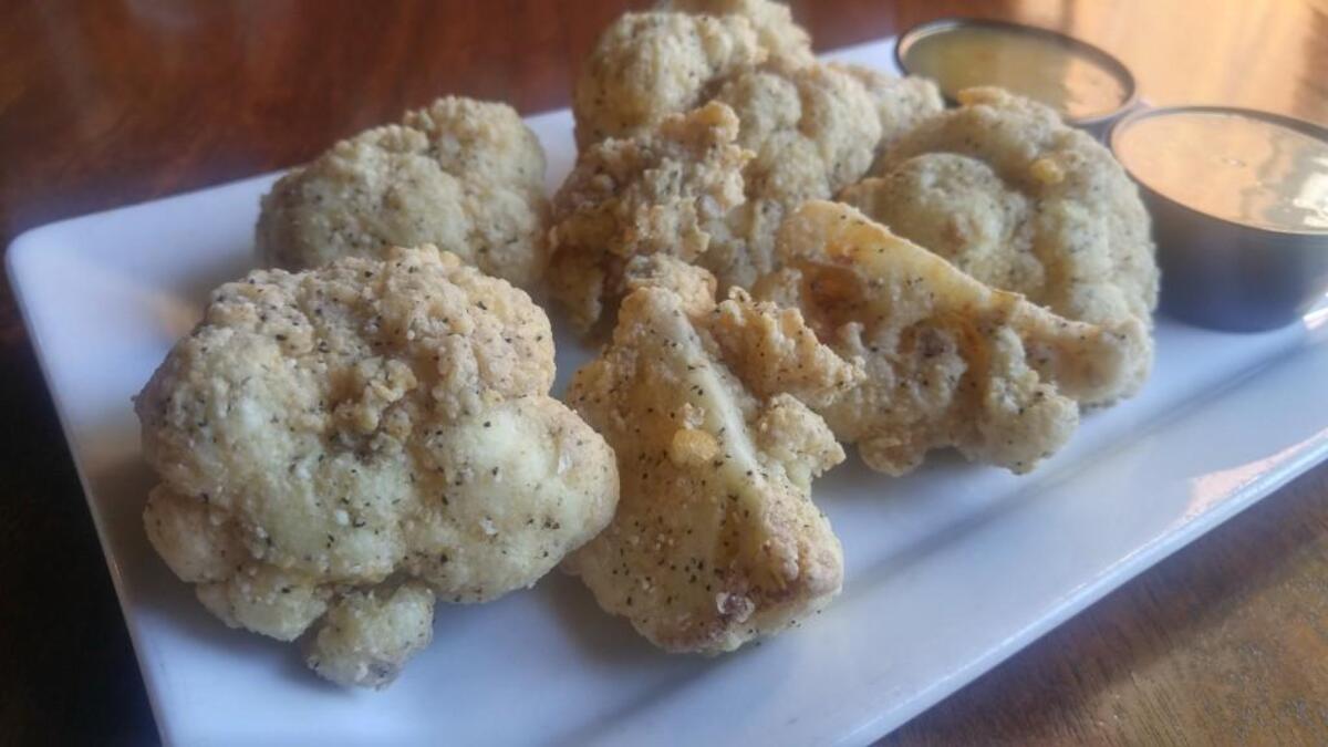 Cauliflower “wings” are quick breaded and fried at Dirty Oscar’s Annex. Accompanying sauces change frequently.