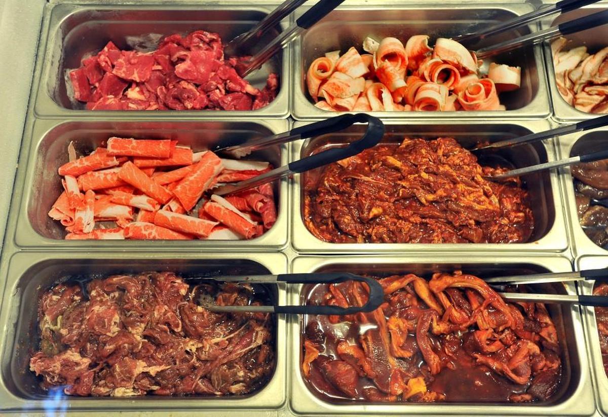 Customers can pick their own meat in a buffet setting at Cham Garden Korean BBQ in Lakewood.