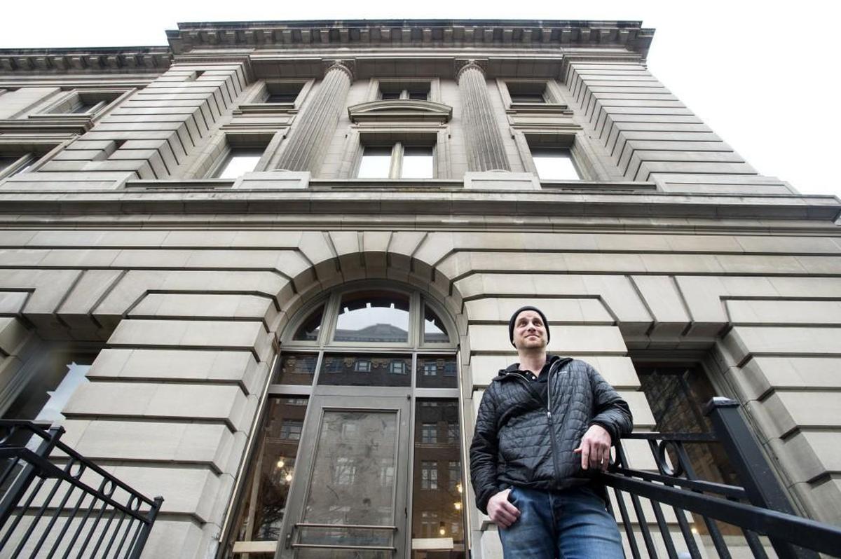 Operator Chris Keil, who previously co-owned Marrow and Hilltop Kitchen, stands outside the entrance of En Rama, a cocktail lounge in downtown Tacoma in the Old Post Office Building.
